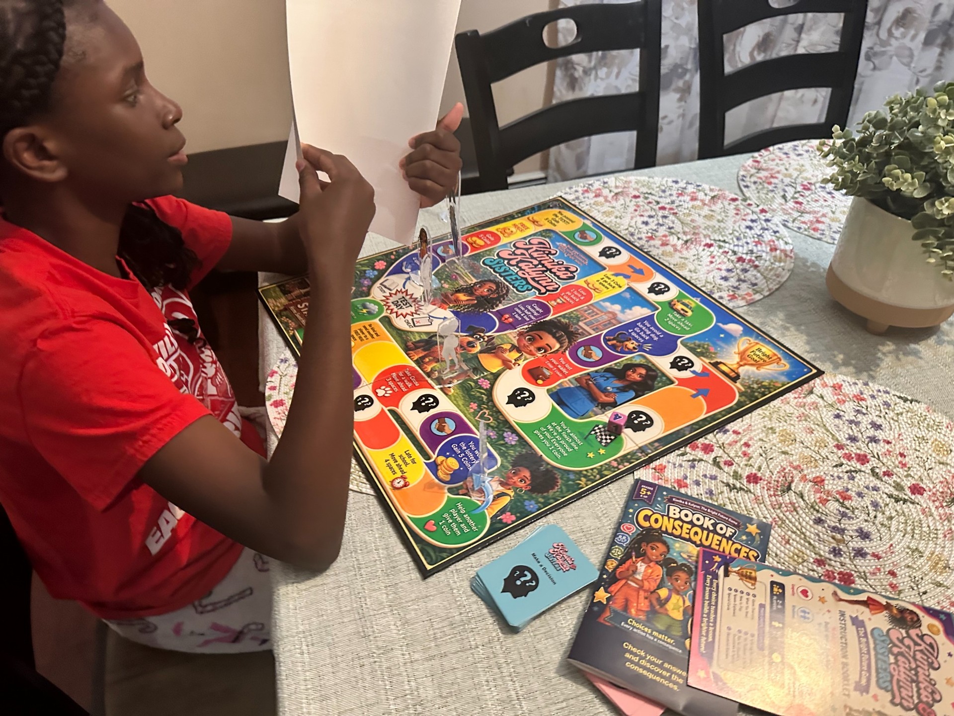 A child reads a Bright Future Game card at the table